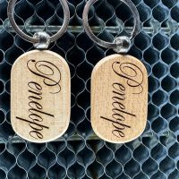 Custom engraved wooden keychain with personalized text.