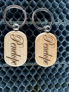 Custom engraved wooden keychain with personalized text.